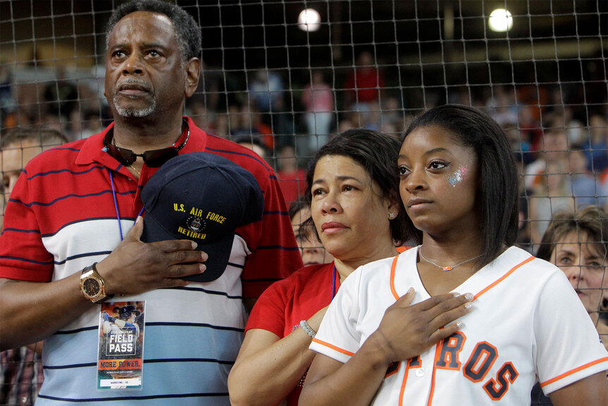 Ron Biles, Nellie Biles, and Simone Biles during the National Anthem before a Houston Astros and Seattle Mariners game