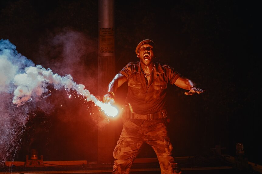 Duncan Kincaid (Mahershala Ali) holds a flare in Jurassic World Rebirth (2025).