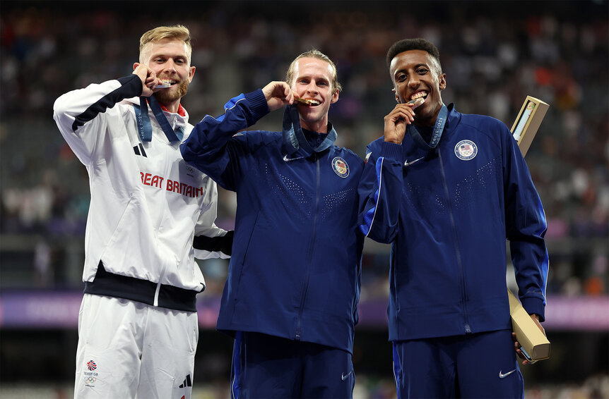 Cole Hocker Josh Kerr and Yared Nuguse stand on the podium at the 2024 Olympics