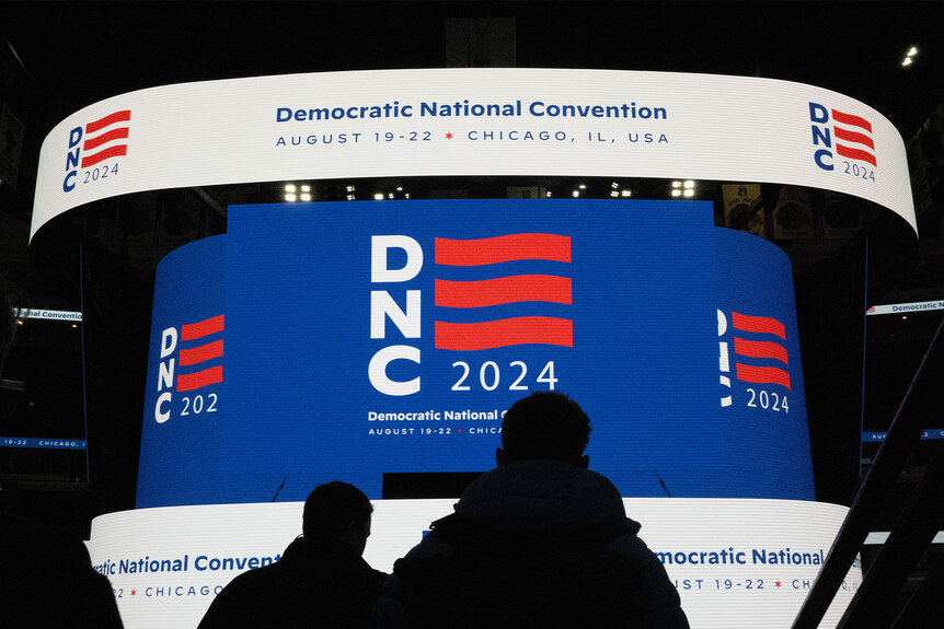 The logo for the Democratic National Convention is displayed on the scoreboard at the United Center during a media walkthrough