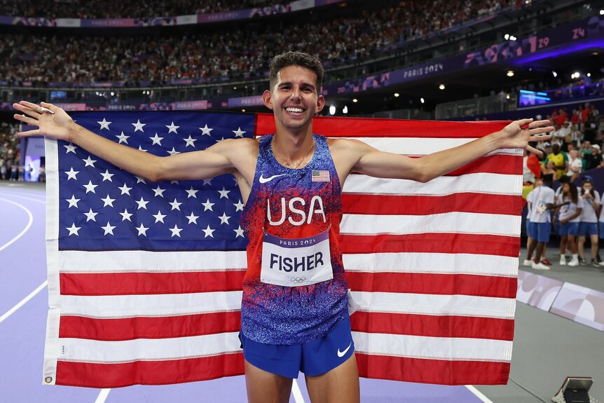 Grant Fisher celebrates his bronze medal win in the men's 10,000m at the 2024 Olympics.