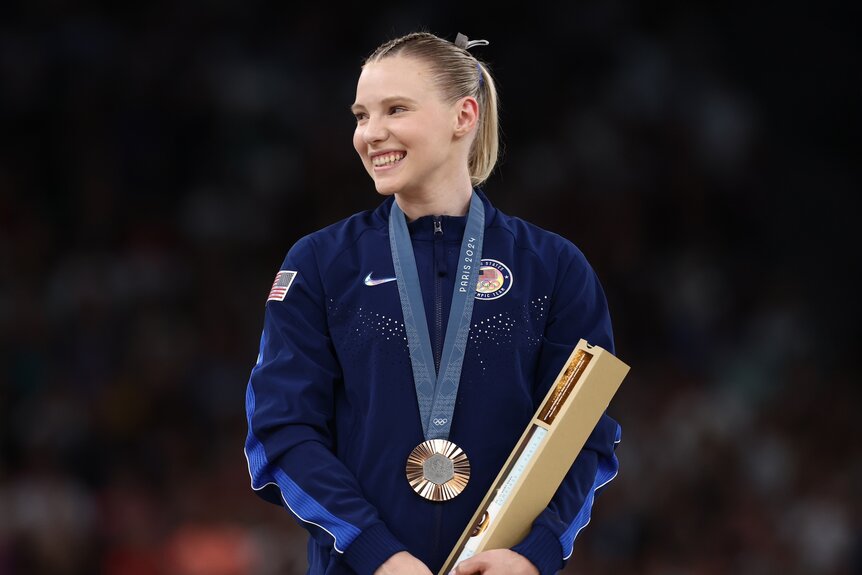 Jade Carey accepts her bronze medal in women's vault at the 2024 Olympics.