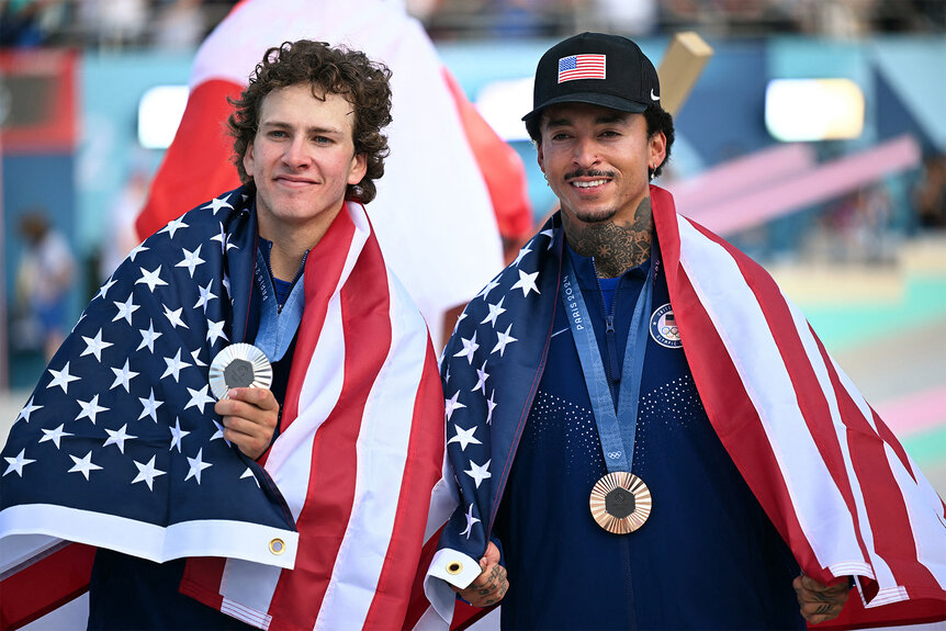 Jagger Eaton and Nyjah Huston wear an american flag and their medals at the 2024 olympics