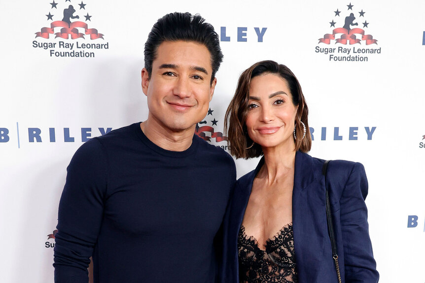 Mario Lopez wears a black sweater with his wife Courtney Mazza