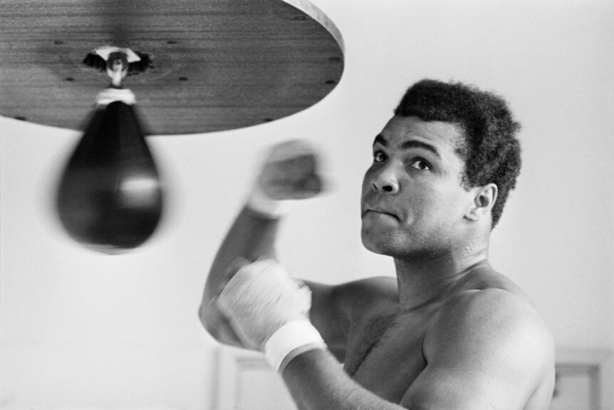 Muhammad Ali practicing on a punching bag.