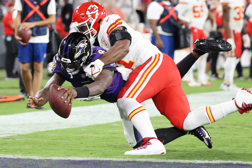 Lamar Jackson #8 of the Baltimore Ravens dives into the endzone past the tackle of Michael Danna #51 of the Kansas City Chiefs