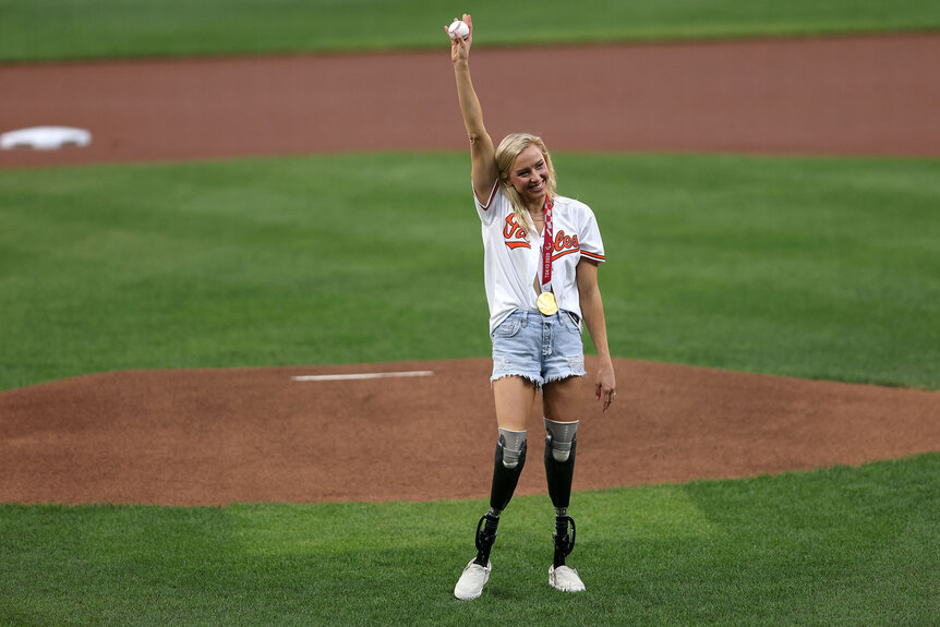 Jessica Long waves to the crowd before throwing out the ceremonial first pitch before the start of a Baltimore Orioles game