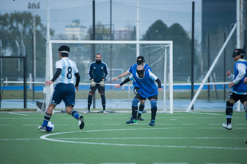 Lucas Rodriguez (l) in action during a training session for Argentina's national blind football team.