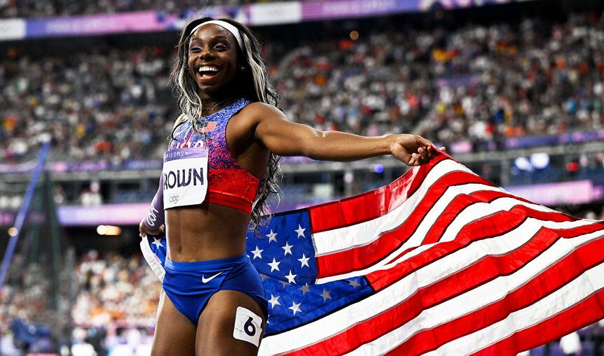 Brittany Brown holding the American Flag after competing in the Paris 2024 Olympics.