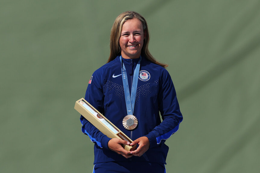 Bronze medalist Austen Jewell Smith of Team United States poses on the podium at the Shooting Skeet Women’s medal ceremony