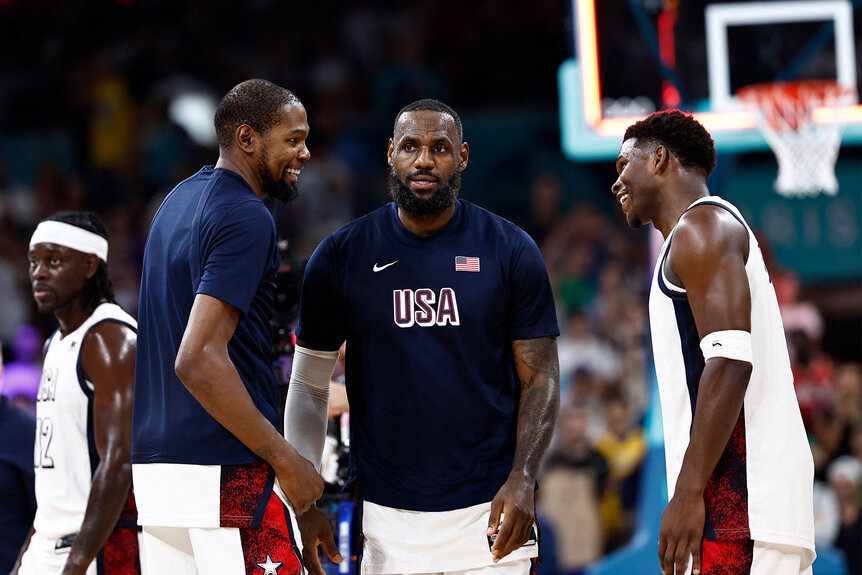 Kevin Durant, LeBron James and Anthony Edwards celebrate after winning the men's preliminary round group C basketball match during the Paris 2024 Olympic Games