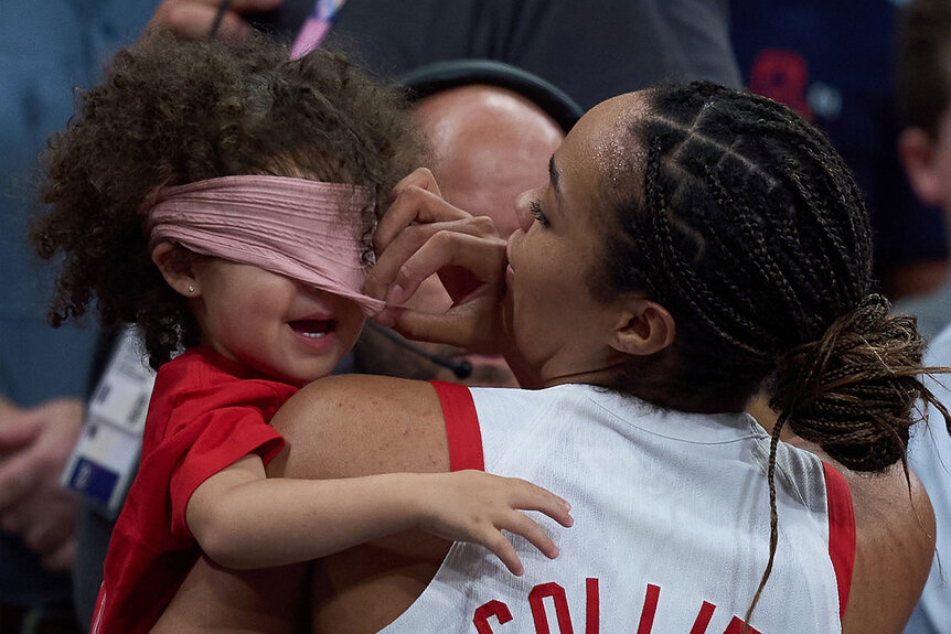 Napheesa Collier of the United States celebrates with her daughter after the women's basketball group C match between the United States and Japan at the Paris 2024 Olympic Games