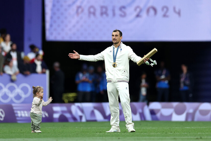 Paulin Riva of Team France celebrates his gold medal with his daughter during the Men’s Rugby Sevens medal ceremony on day one of the Olympic Games Paris 2024