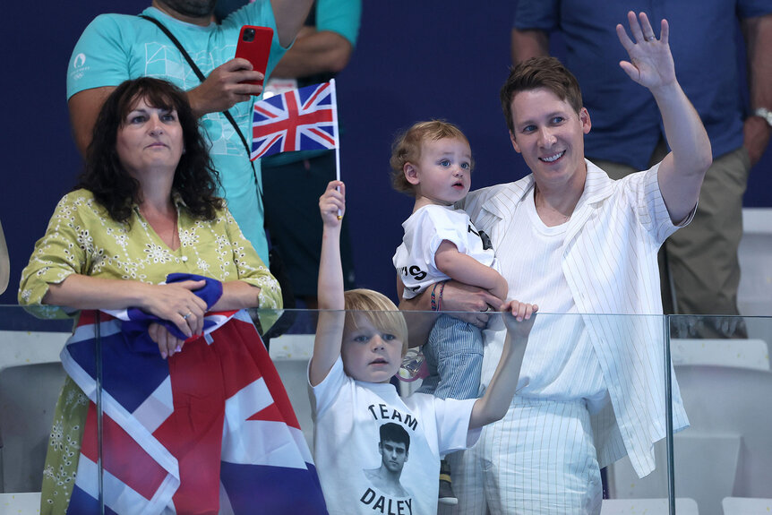 Debbie Daley, mother of Thomas Daley, Dustin Lance Black, husband of Thomas Daley, and their children are seen in attendance as they show their support ahead of the Men’s Synchronised 10m Platform Final