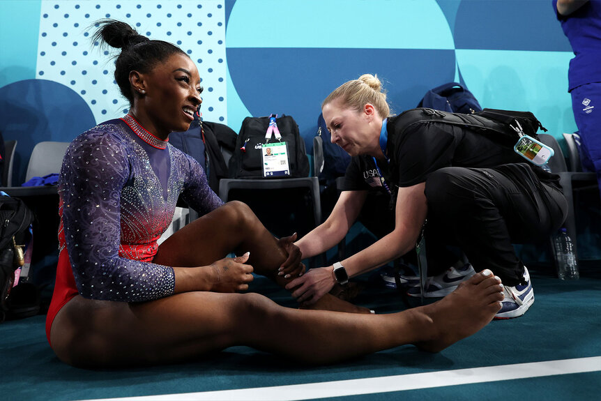 Paris 2024 Olympics Simone Biles has her calf examined by medical staff during the Artistic Gymnastics Women's Floor Exercise Final at the Paris 2024 Olympics