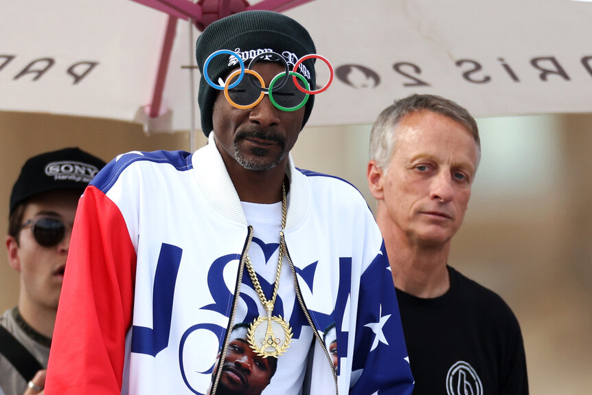 Snoop Dogg and Tony Hawk watch skateboarding during the 2024 Olympics