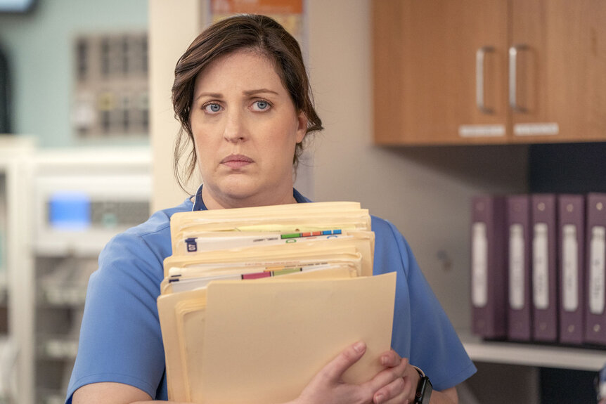 Alex holding files during the Pilot Episode of St. Denis Medical.