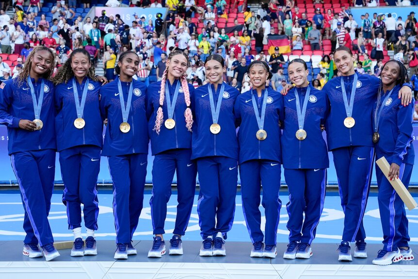 The U.S. Women's Soccer Team pose with their gold medals at the 2024 Olympics