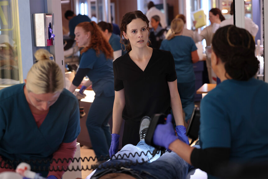 Dr Caitlin Lenox stand over a patient on Chicago Med Season 10 Episode 1