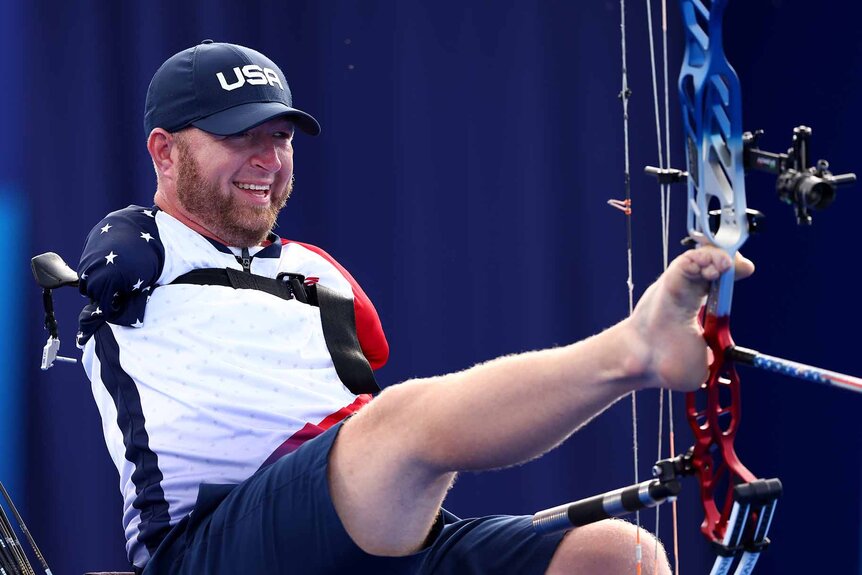 Matt Stutzman shoots a bow and arrow with his feet at the 2024 Paralympic Games.