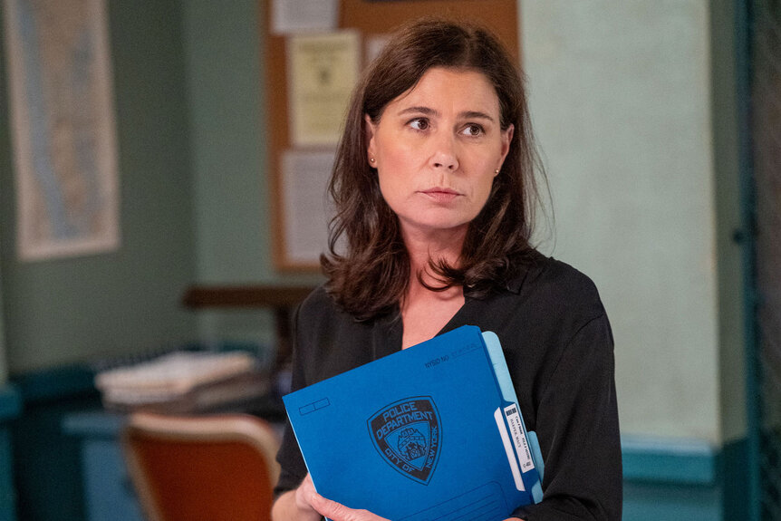 Lt. Jessica Brad (Maura Tierney) holds a case file in Law and Order