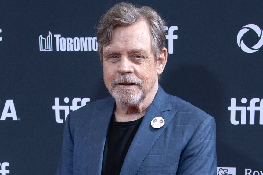 Mark Hamill wears a blue suit on the red carpet at TIFF