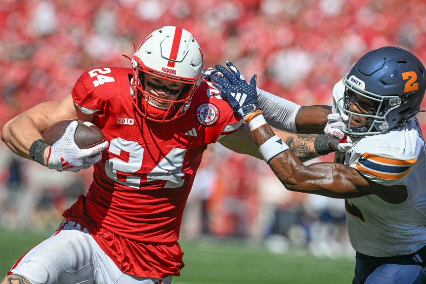 Thomas Fidone II #24 of the Nebraska Cornhuskers runs from Xavier Smith #2 of the UTEP Miners