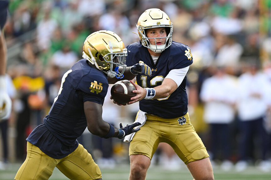 Notre Dame Football players during a play on the field