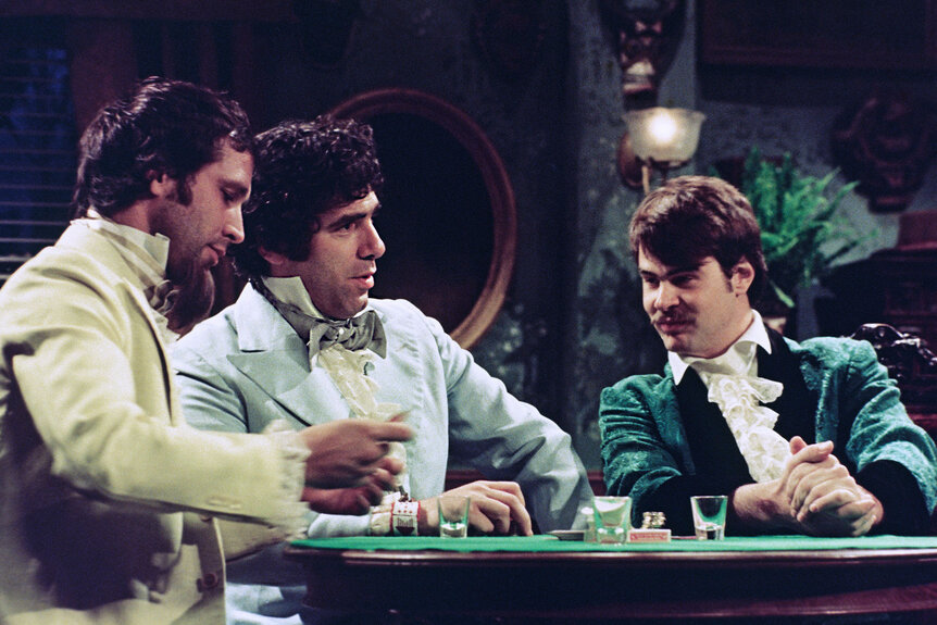 Chevy Chase as Ramone Diarga, Elliott Gould as Moe Greenstein, Dan Aykroyd as Mr. Russo during "Foreign Card Playing" skit