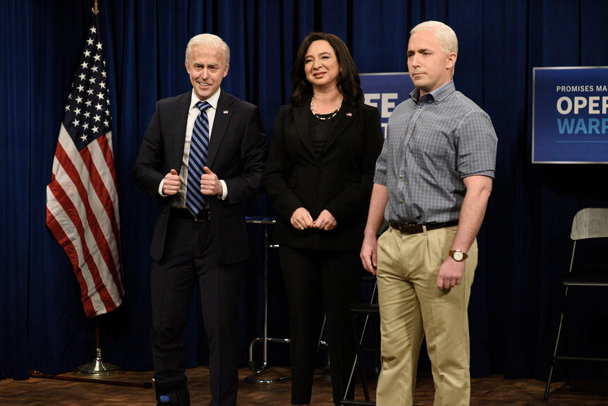 Alex Moffat as Joe Biden, Maya Rudolph as Kamala Harris, and Beck Bennett as Mike Pence standing onstage together