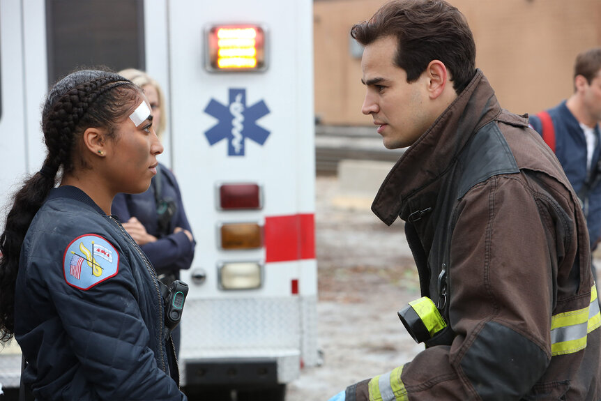 Gianna Mackey (Adriyan Rae) and Blake Gallo (Alberto Rosende) talk to each other on Chicago Fire Season 9 Episode 2.