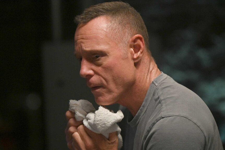 Hank Voight holds a towel to his face on Chicago P.D. Season 12 Episode 4.