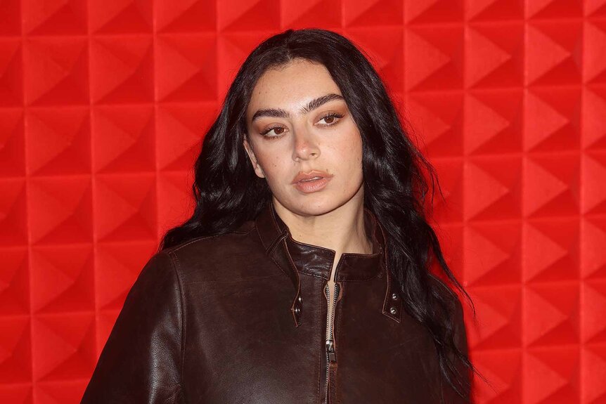 Charli XCX wears a leather jacket.