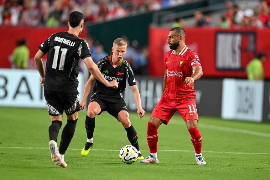 Liverpool forward Mohamed Salah (11) dribbles a football.