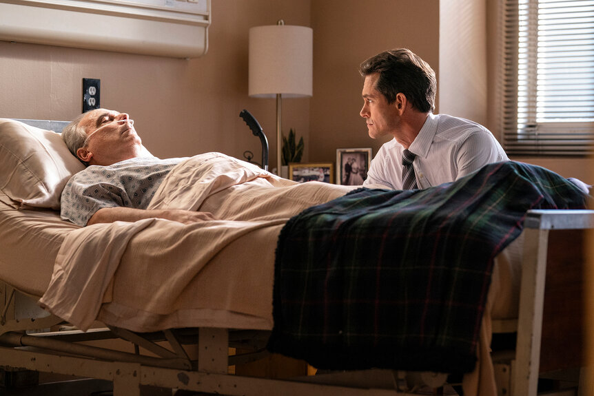 Nolan Price sits at his fathers hospital bed on Law & Order Season 24 Episode 4