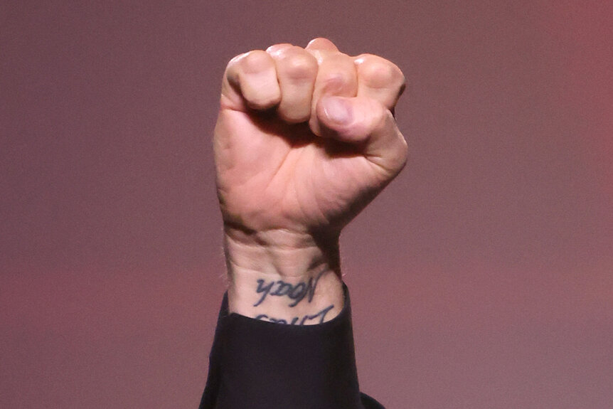 Michael Bublé holds up his fist showing off his 'noah' tattoo