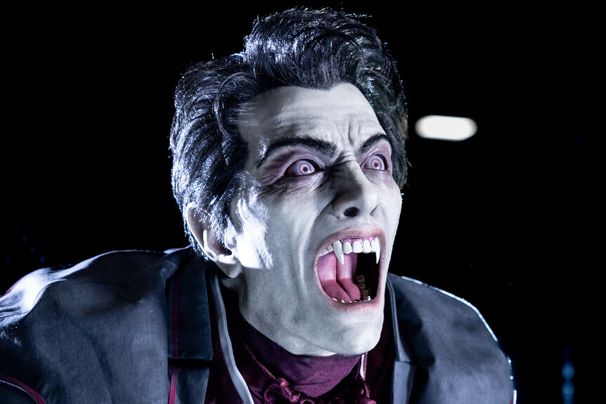 An Animatronic statue of dracula showing his teeth