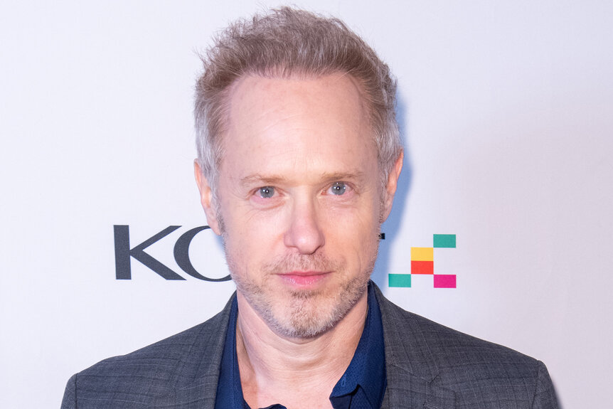 Raphael Sbarge on the red carpet in a dark grey blazer