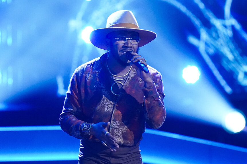 J. Paul wears a hat while he sings on stage on the voice season 26 episode 4