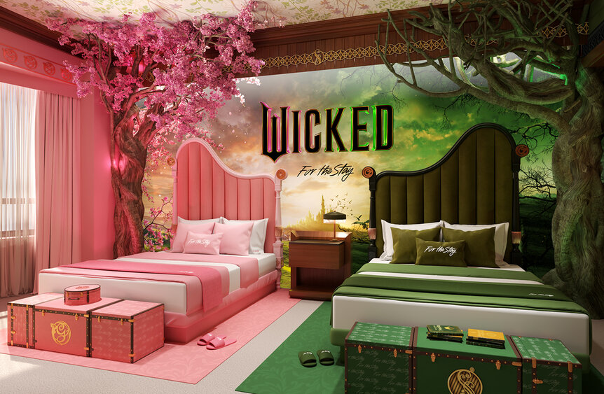 A hotel room with a pink and green bed with the wicked movie poster from Hilton