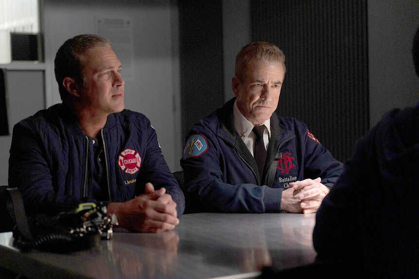 Kelly Severide and Chief Dom Pascal sit at a table on Chicago Fire Season 13 Episode 7