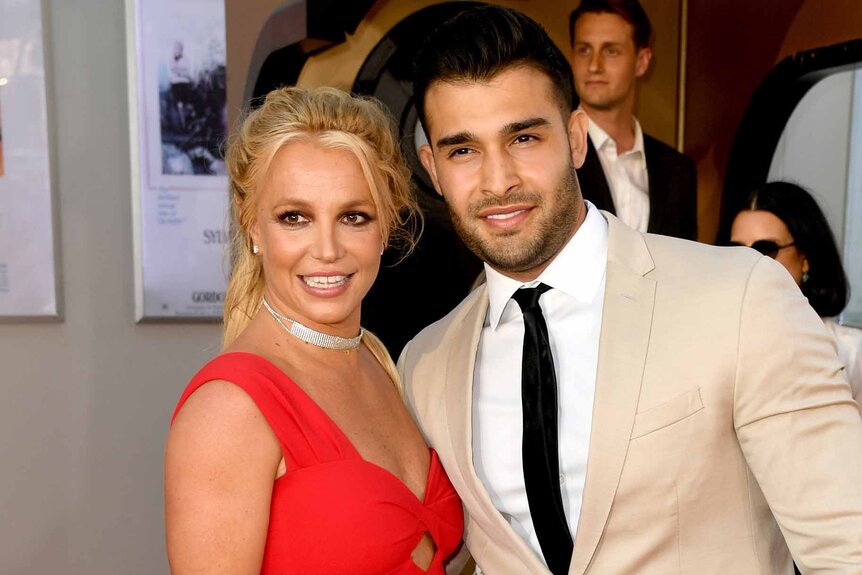 Britney Spears and Sam Asghari smile together.