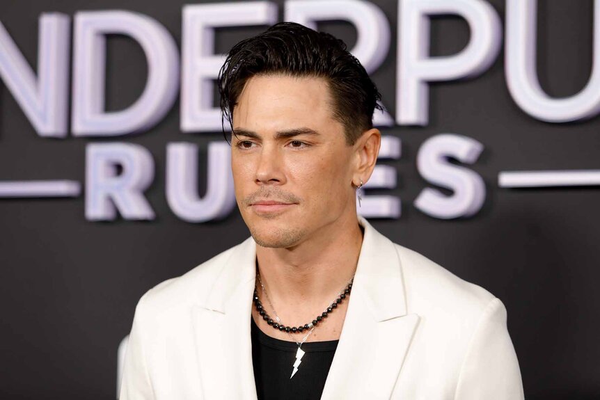 Tom Sandoval poses in a white blazer.