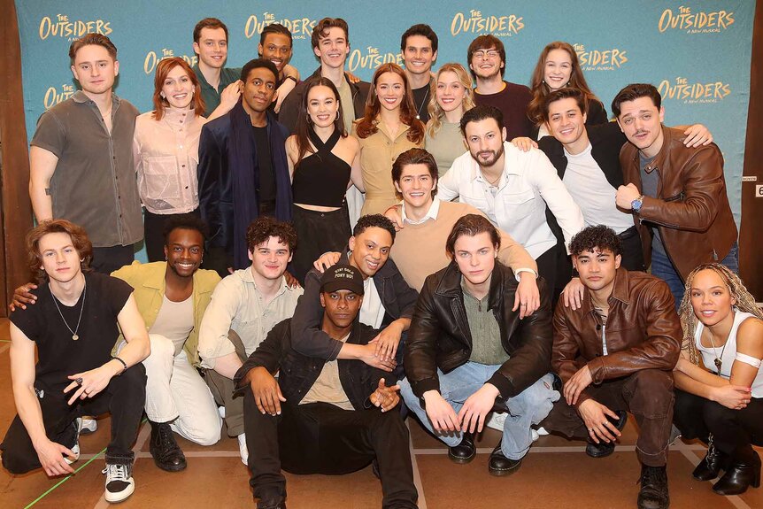 The Cast of "The Outsiders" pose together.