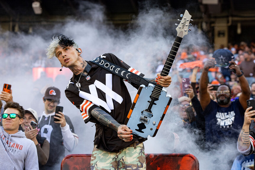 Machine Gun Kelly performs before the Cleveland Browns home game against the Dallas Cowboys