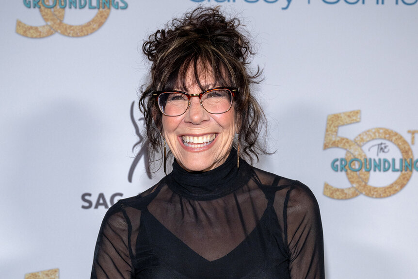 Mindy Sterling smiles in a sheer dress on the red carpet