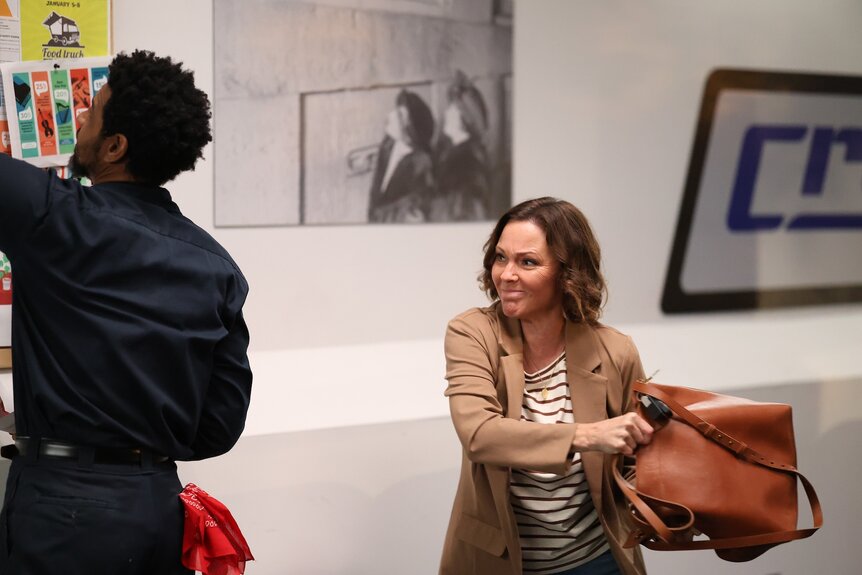 Margaret (Kelli Williams) prepares to swing a purse at a man in Found Episode 206.