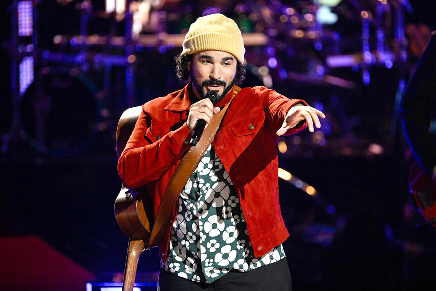 Adam Bohanan sings on stage on The Voice Season 26 Episode 16