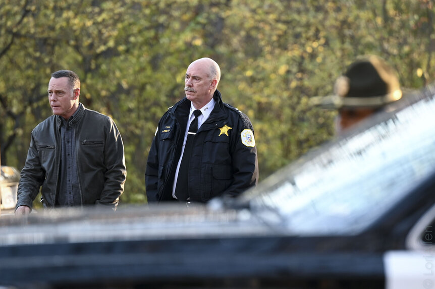 Hank Voight (Jason Beghe) and Chief O'Neal (Michael Gaston) walking outdoors in Chicago P.D. Season 10, Episode 1.