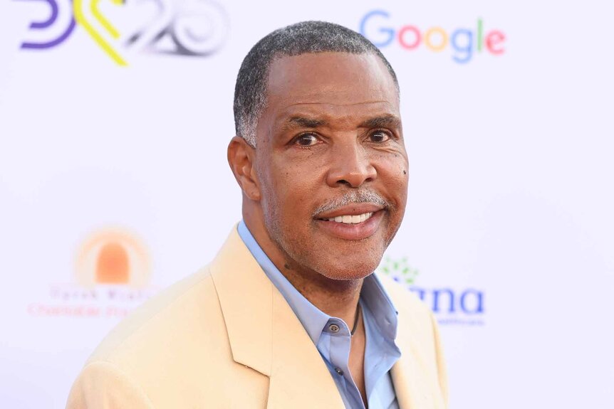 Eriq La Salle smiles in a tan blazer.